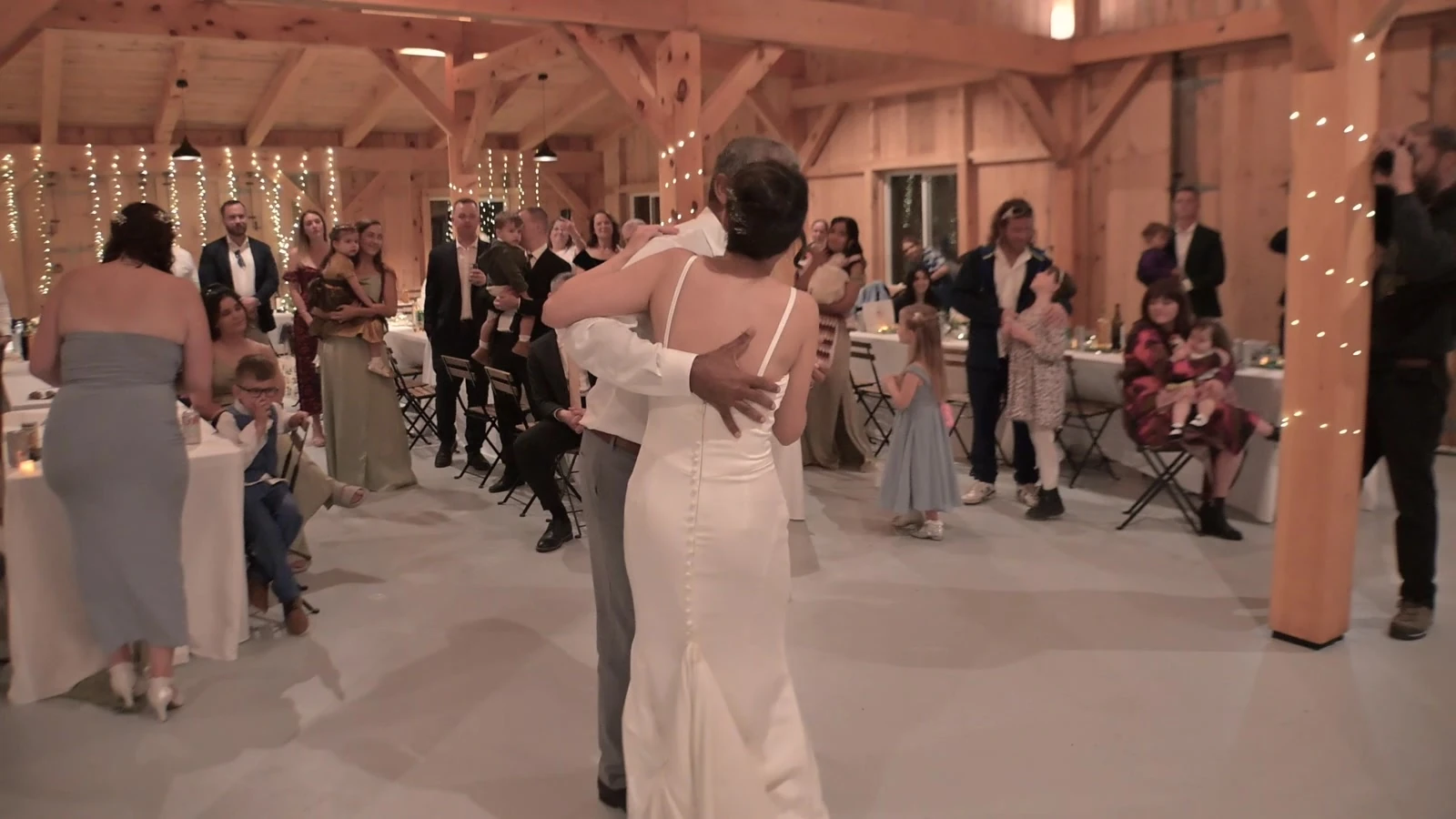 Kevin and Jodie dancing inside a timber reception venue